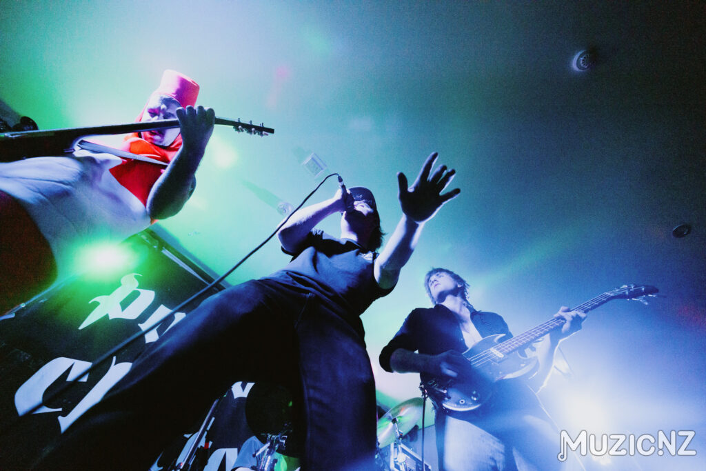 Punk Rock band, Red Weekend playing live on stage with lots of movement and colourful lighting