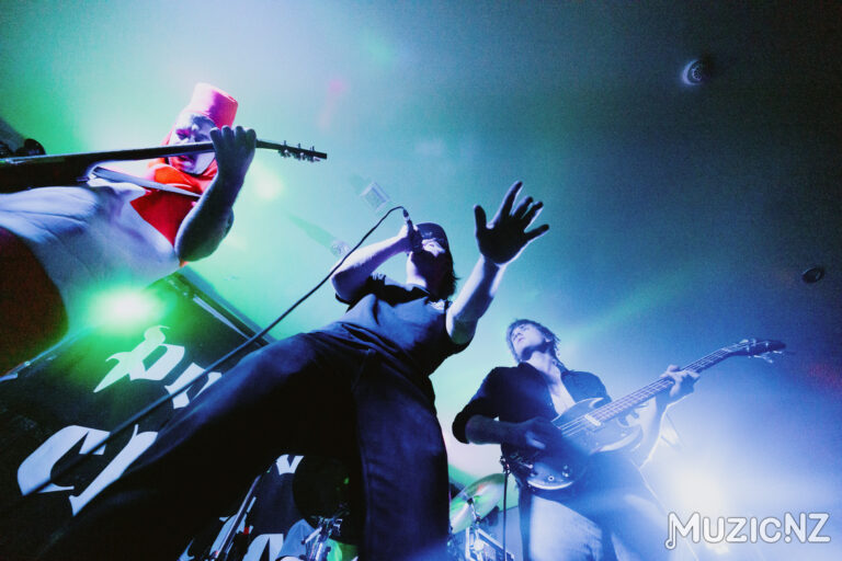 Punk Rock band, Red Weekend playing live on stage with lots of movement and colourful lighting