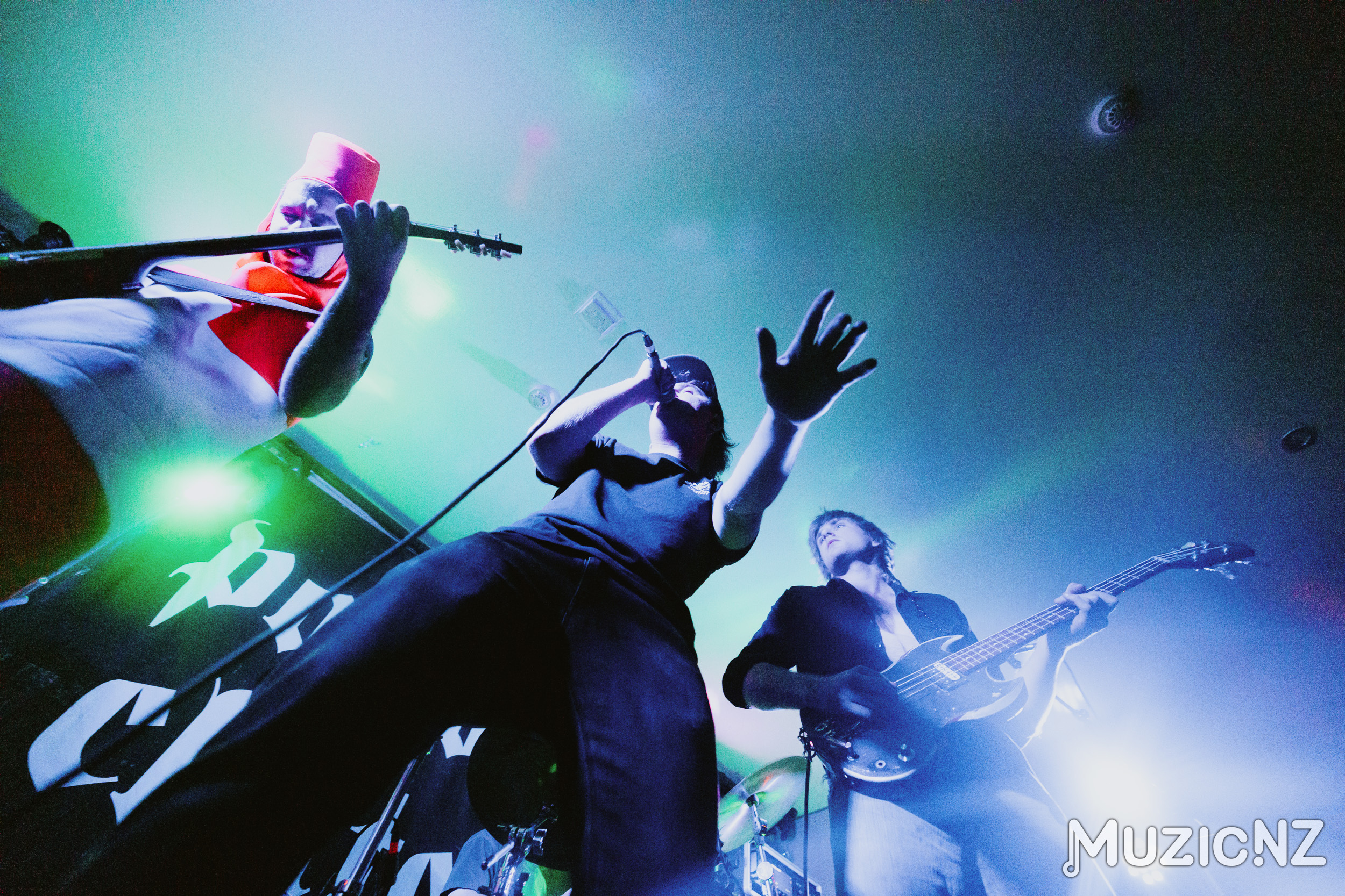 Punk Rock band, Red Weekend playing live on stage with lots of movement and colourful lighting