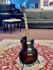 Rock Band Powder Chutes Donates A Gibson Les Paul To Mount Aspiring College